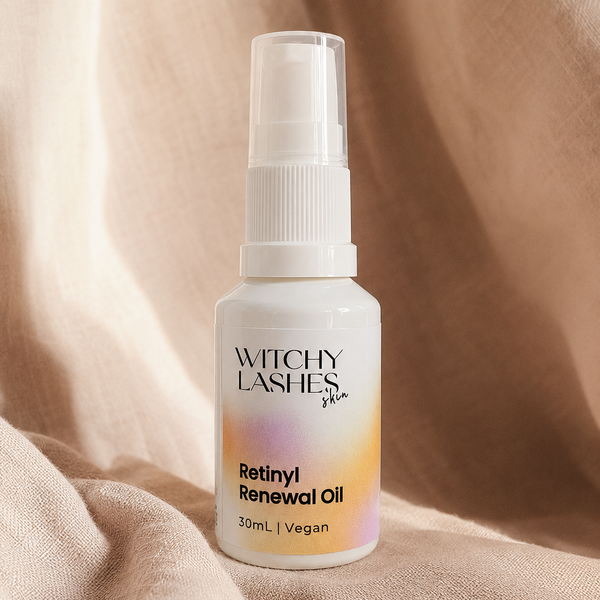 Bottle of Witchy Lashes Retinyl Renewal Oil on a beige fabric background