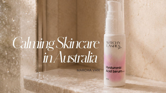 Witchy Lashes Skin Hyaluronic Acid Serum bottle in a marble shower niche with water droplets on the wall