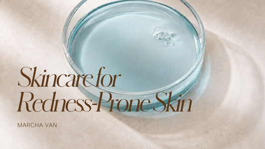 Glass petri dish containing pale blue liquid serum, photographed from above on a beige linen surface